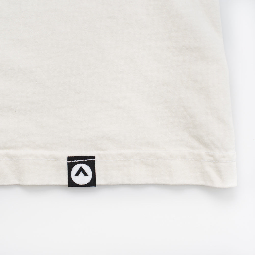 Black Hem tag showing Elevation logo on white shirtn